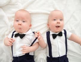 Identical twins in tuxedo with suspenders